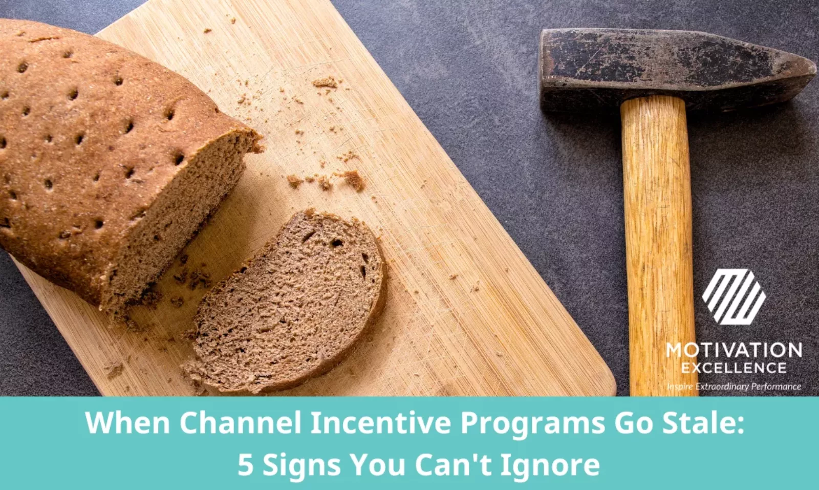 A loaf of stale bread and a pick ax on a bread board.